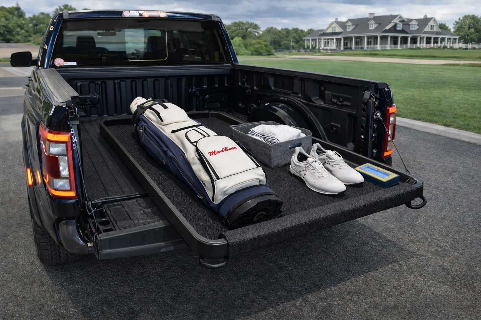 BagSled in truck bed with premium golf bag secured at golf course